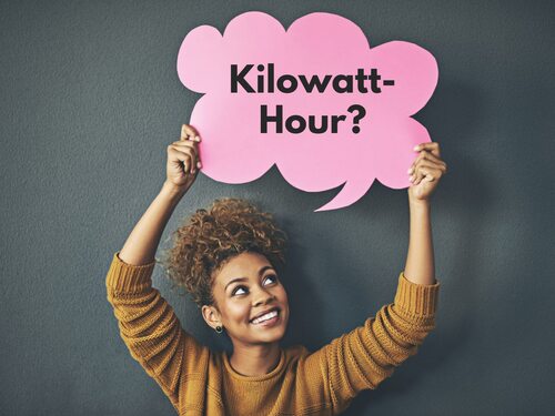 Woman holding a thought bubble that reads kilowatt-hour