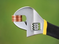 Adjustable wrench holding pennies