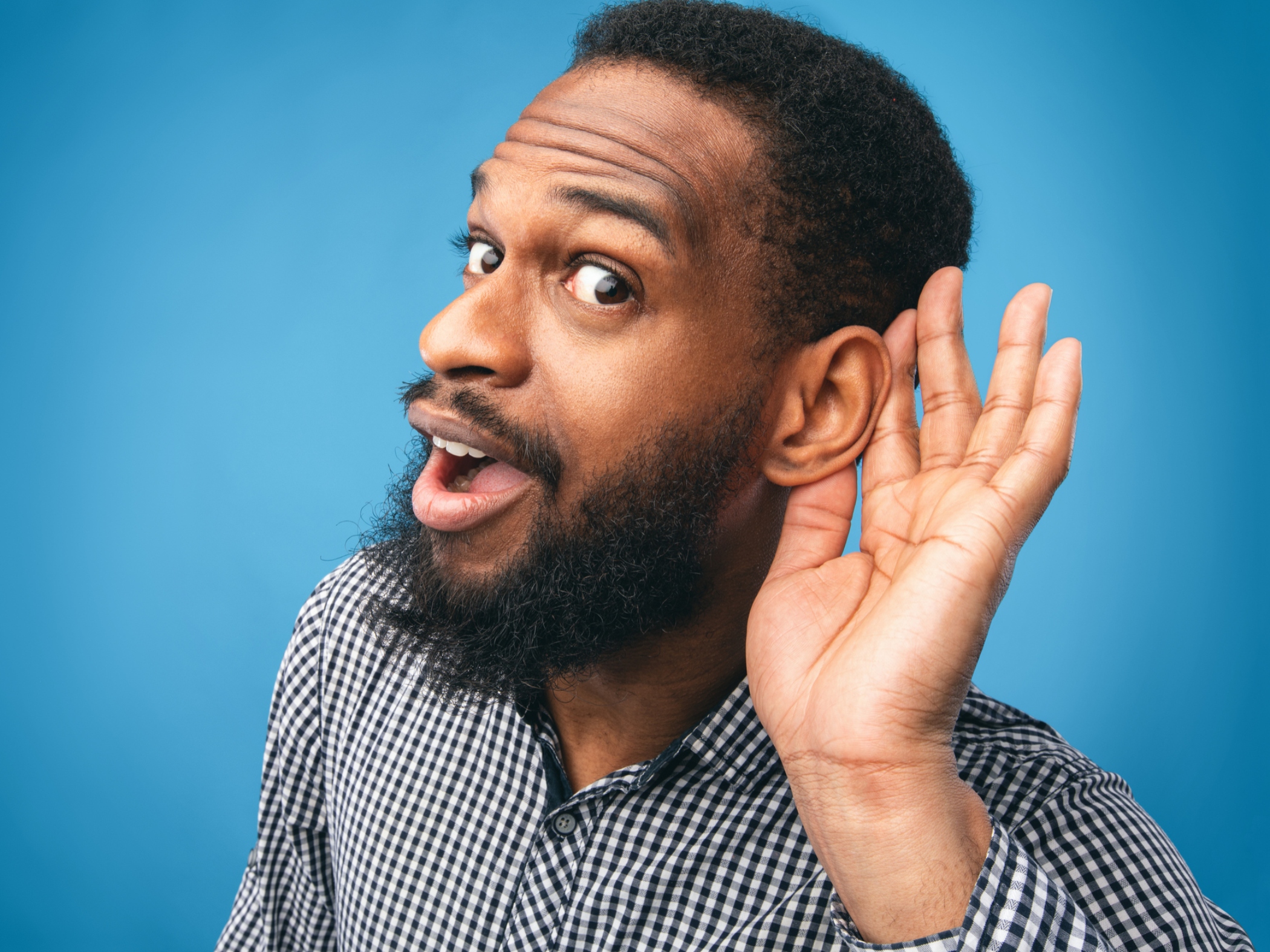 Man holding ear to listen