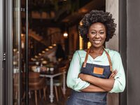 Business owner standing in front of restaurant