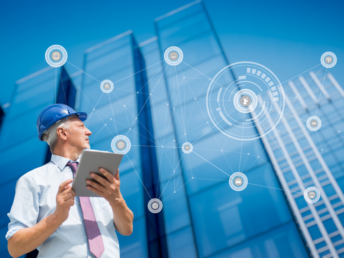 Engineer with tablet looking at buildings