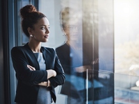 Businesswoman looking out window in office