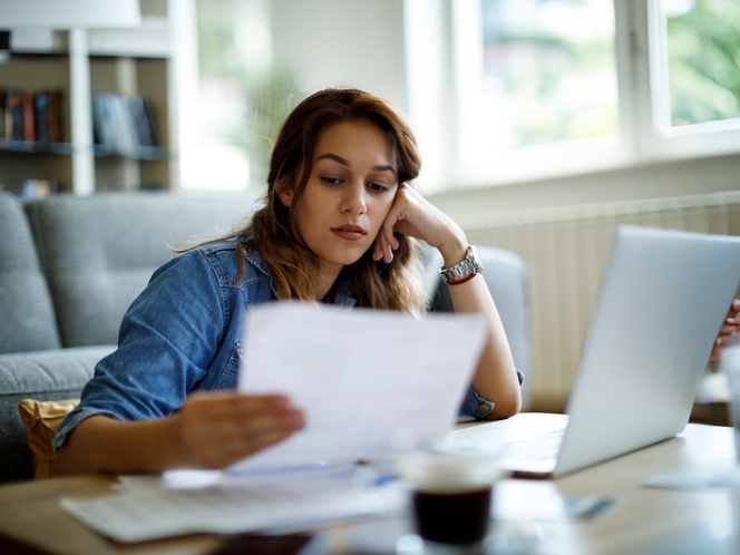 Woman looking at bills