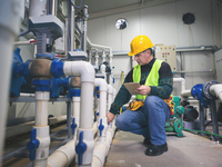 Worker evaluating steam system equipment