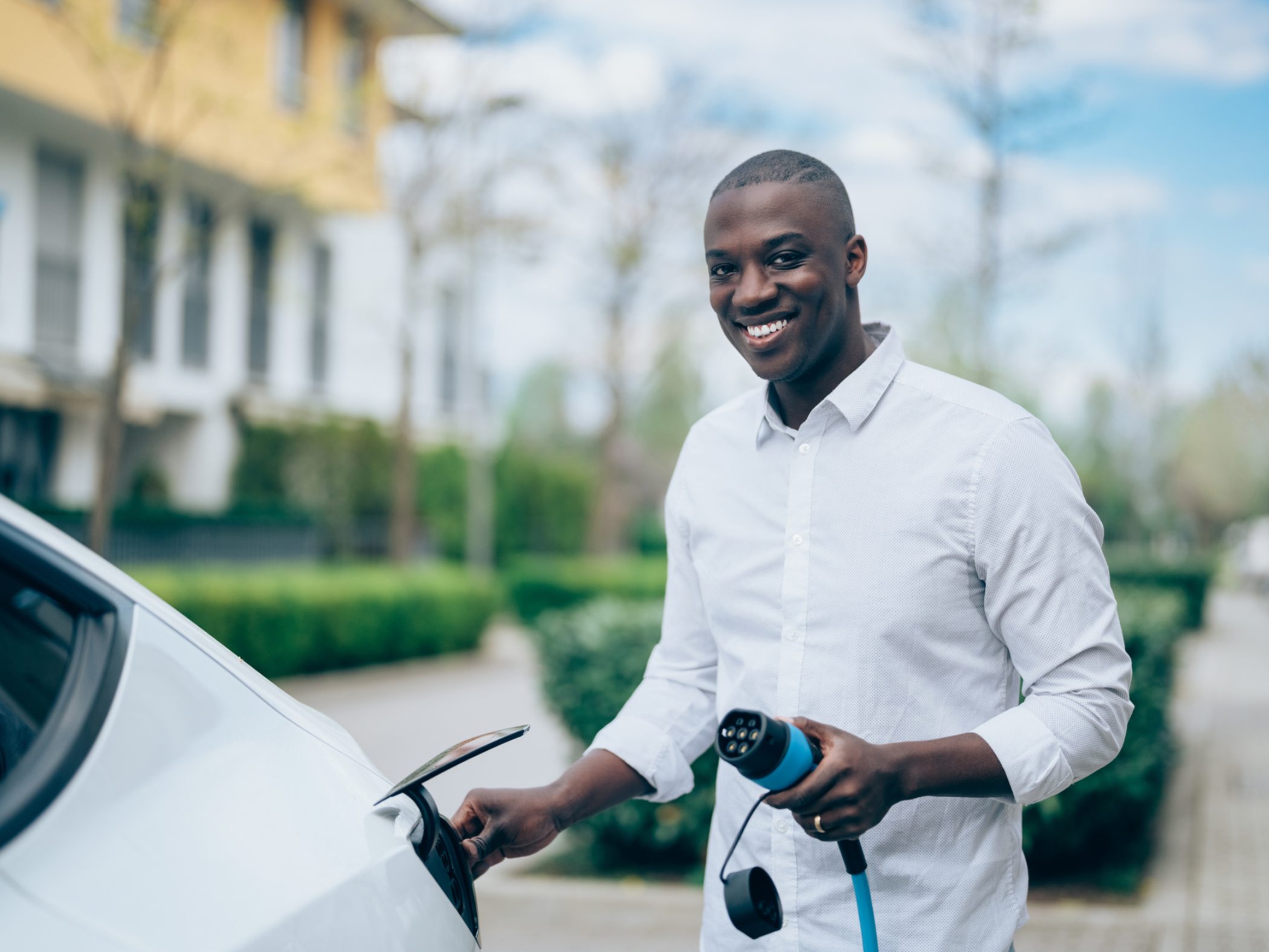 Man charging an electric vehicle