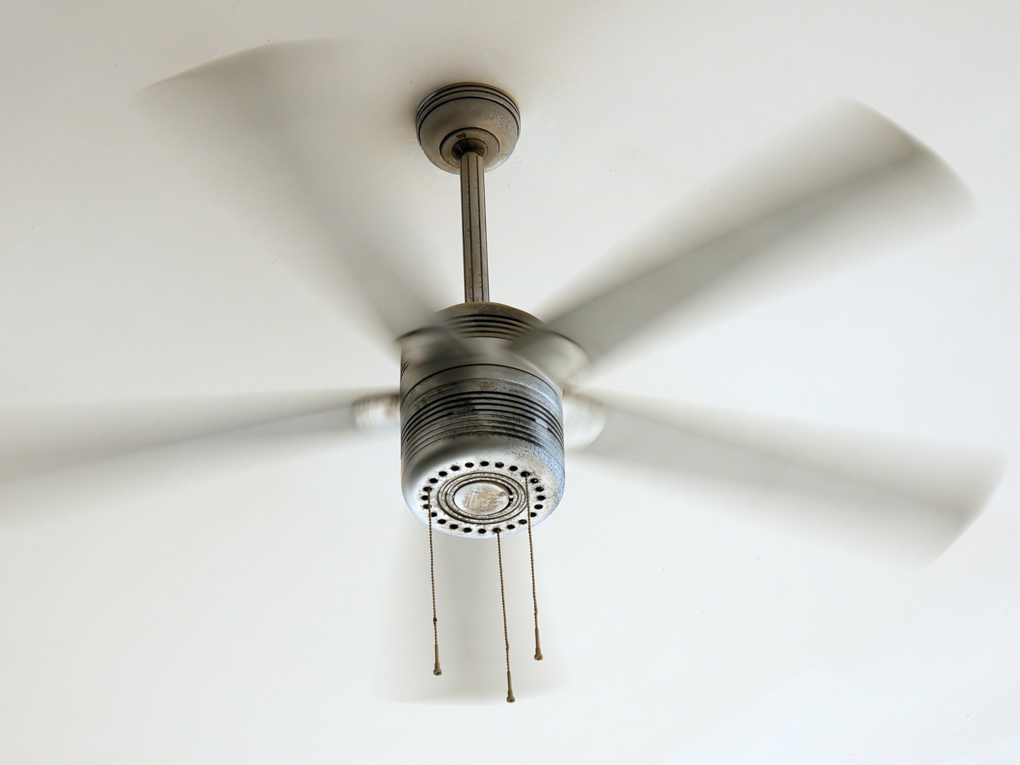 A vintage ceiling fan spinning
