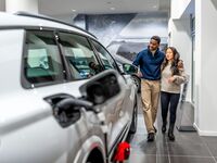 Looking at car in dealership