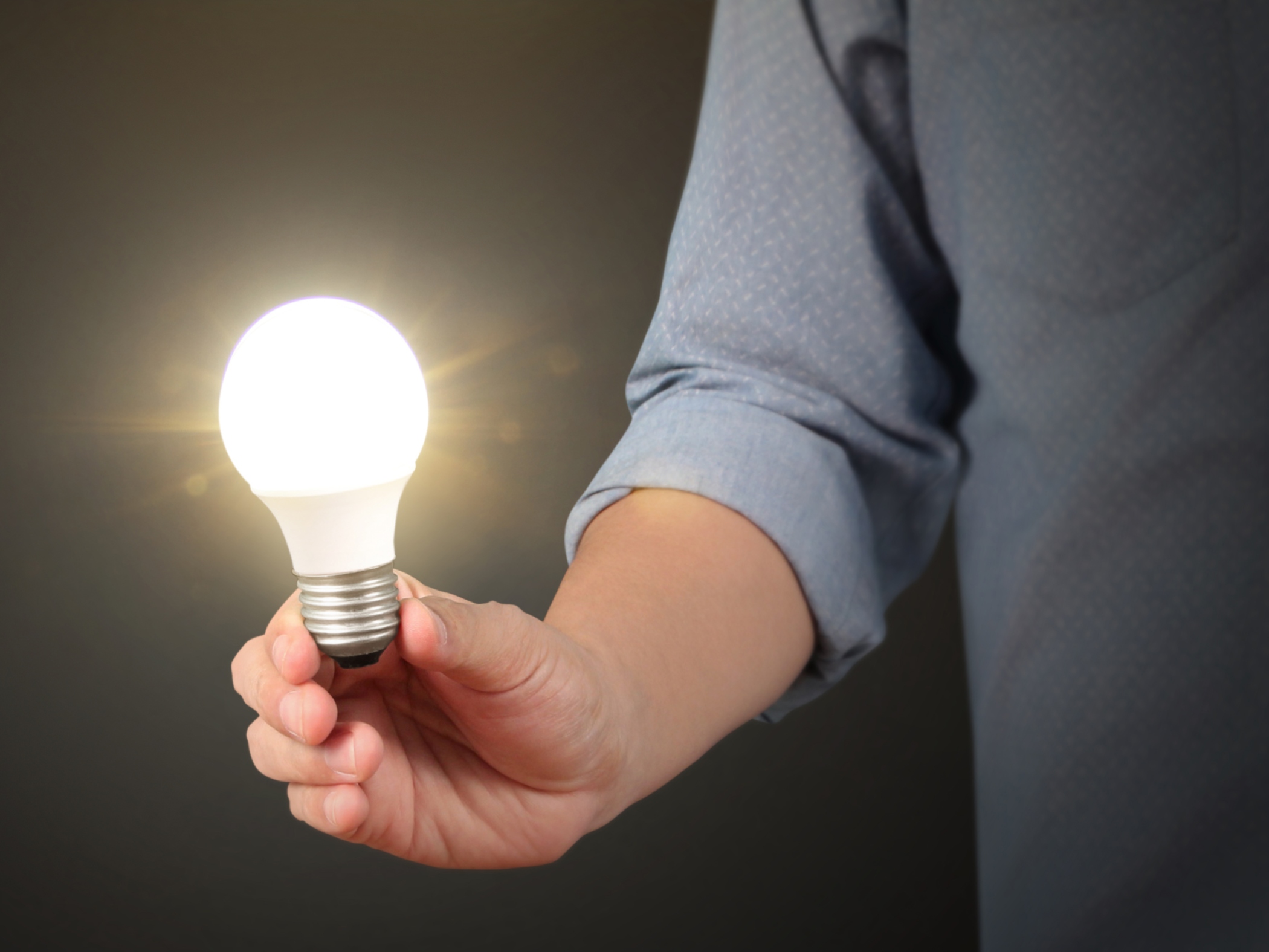 Man holding LED bulb