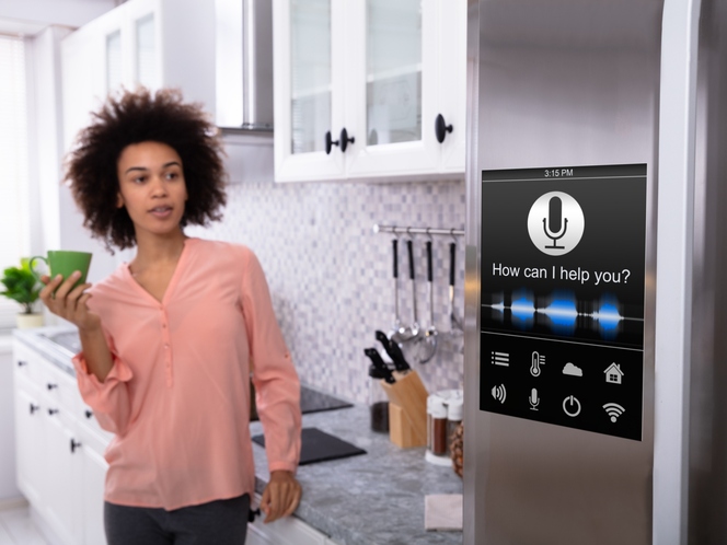 Woman looking at smart refrigerator