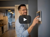 Man adjusting thermostat