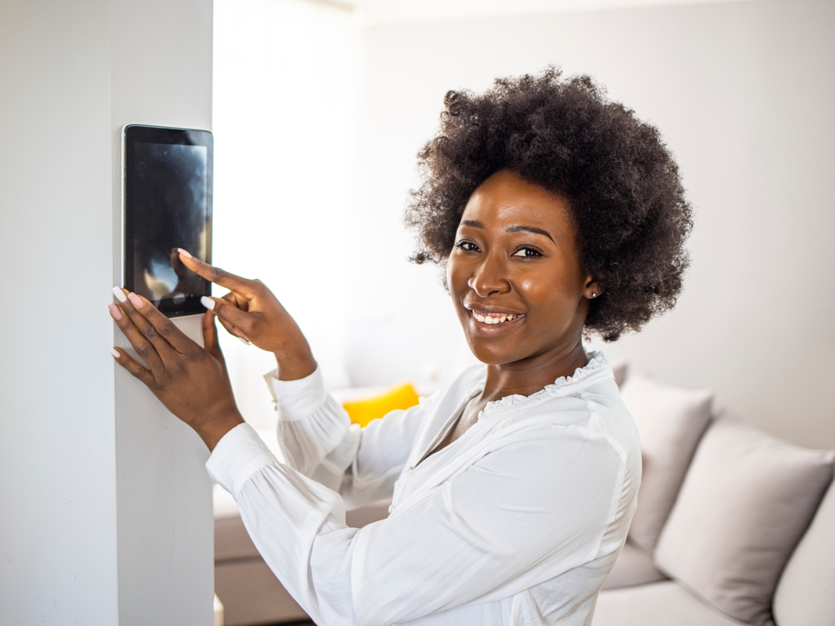 Woman using tablet to set up smart home
