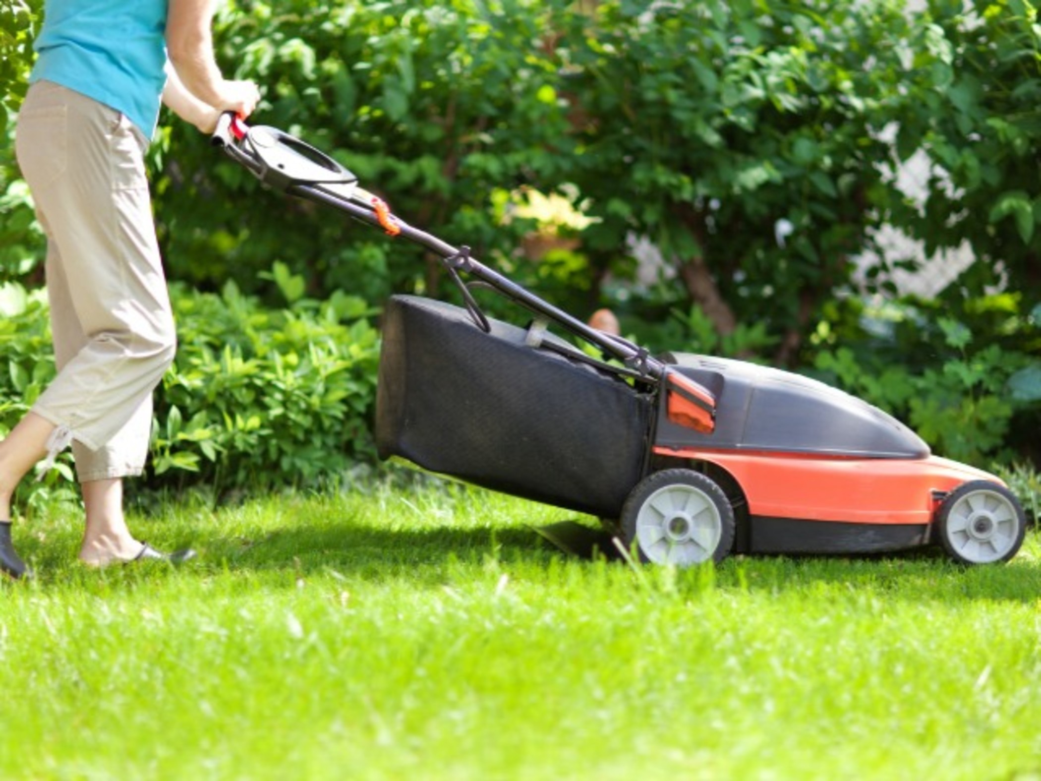 Woman using cordless mower